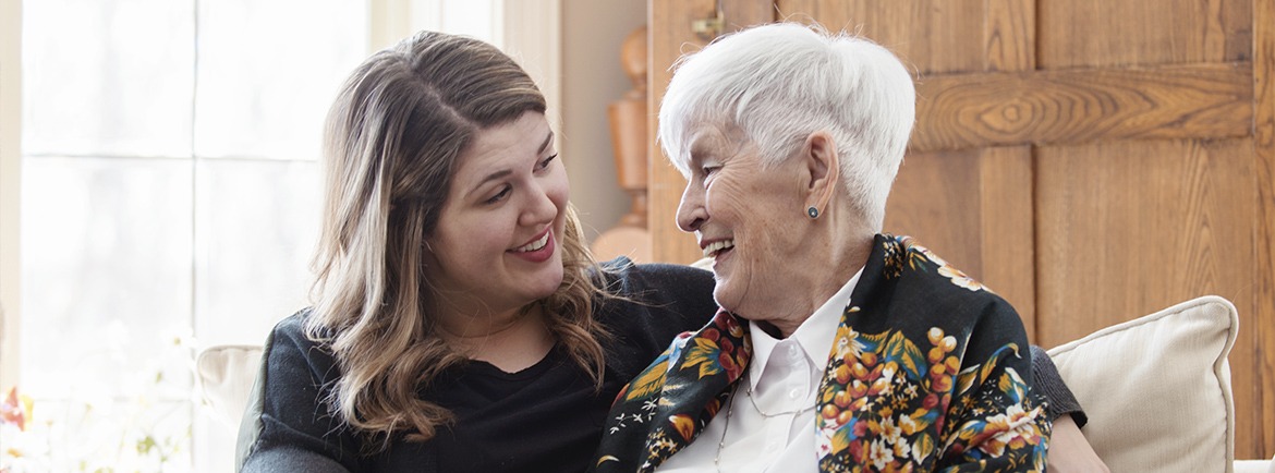 Mother and daughter sitting together smiling