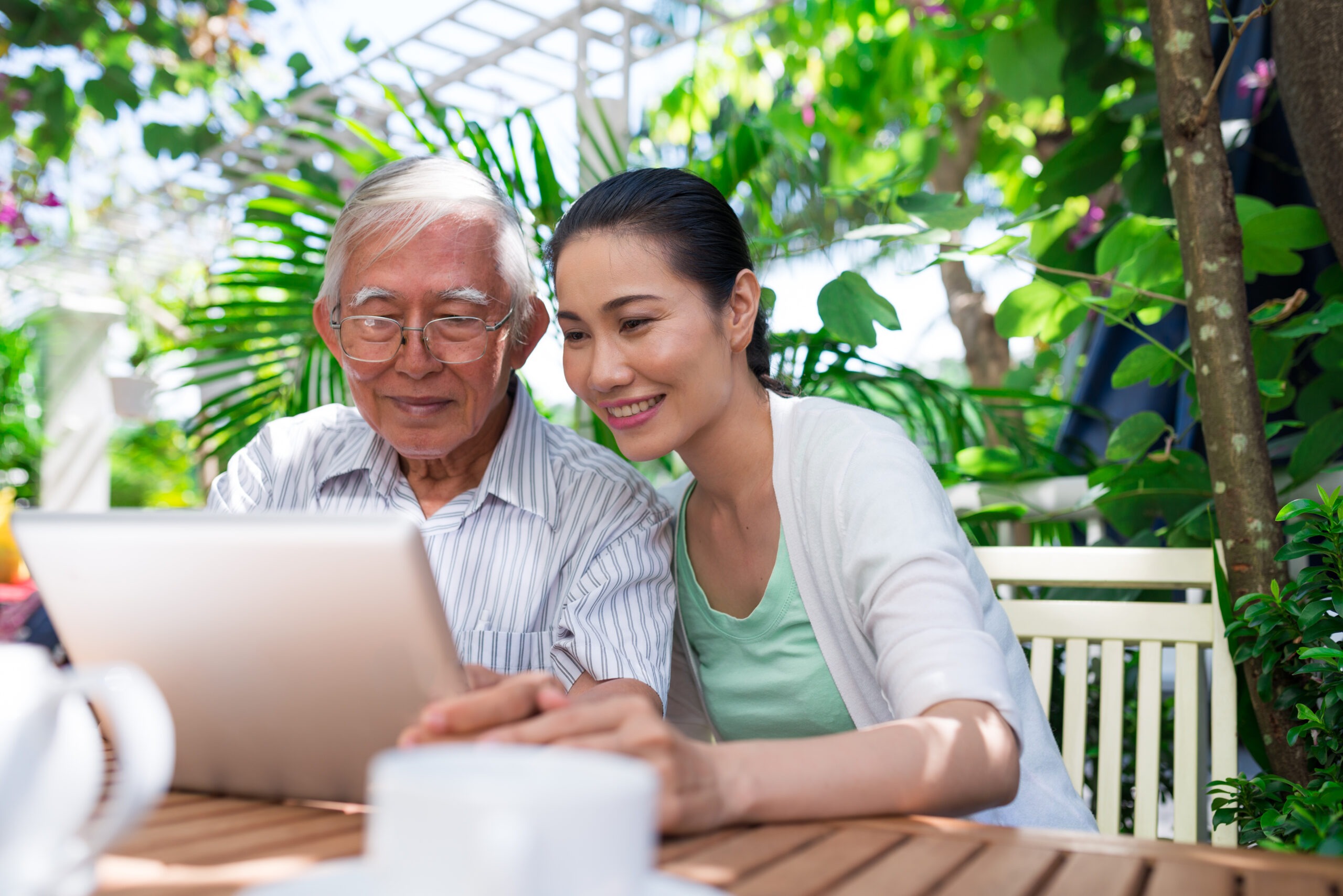 Man and daughter looking at tablet screen