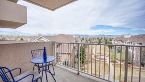 Apartment porch with blue bistro table and chairs