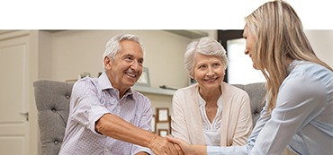 Woman shaking older mans hand